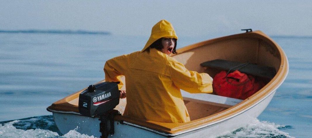Benee steering a small boat