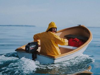 Benee steering a small boat